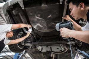 mechanic-checking-car-suspension