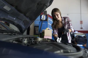 woman changing car oil